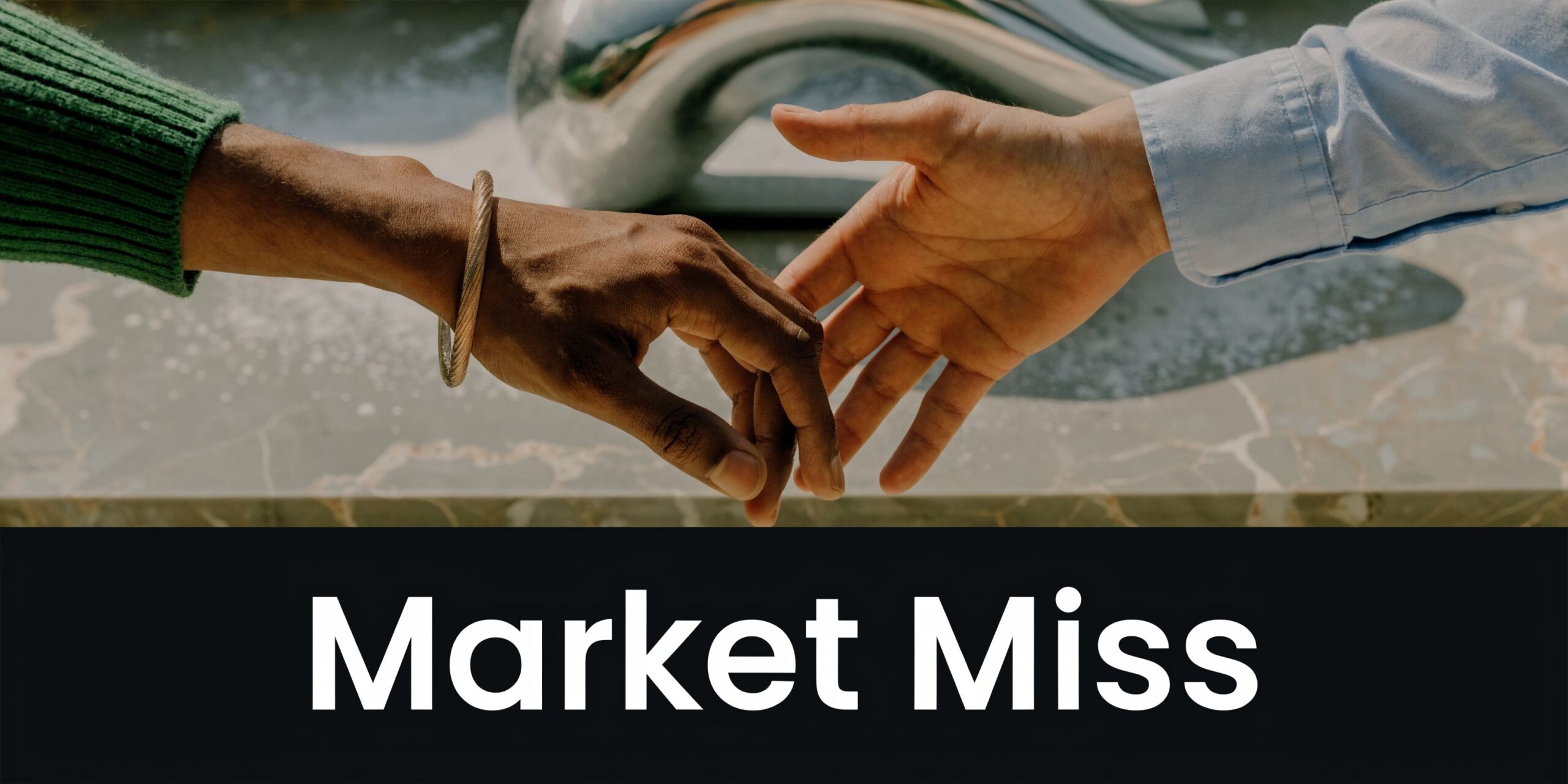 A close-up shot showing two hands reaching toward each other over a surface with the text Market Miss.